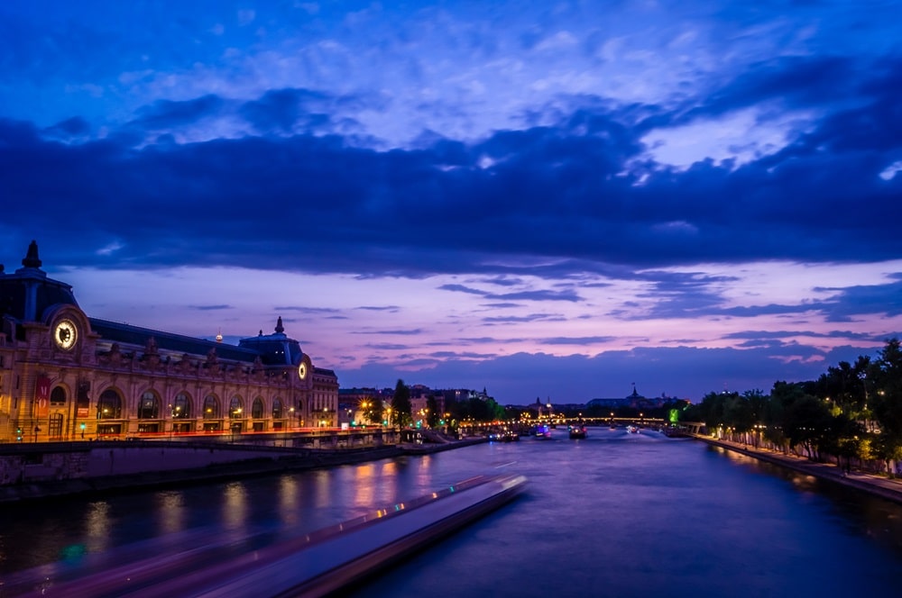vistacreate 182904686 stock photo seine and orsay museum at night min