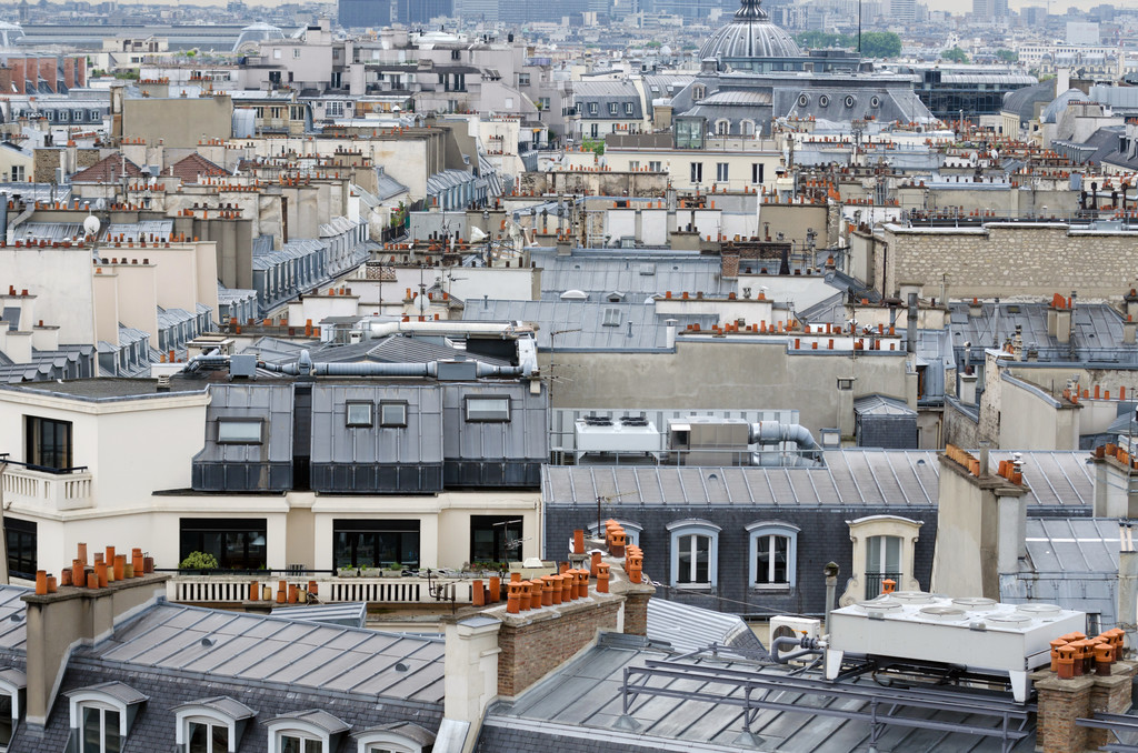 Vue sur les toits d’immeubles parisiens, illustrant l’environnement d’un appartement à Paris lors d’une vérification à distance.
