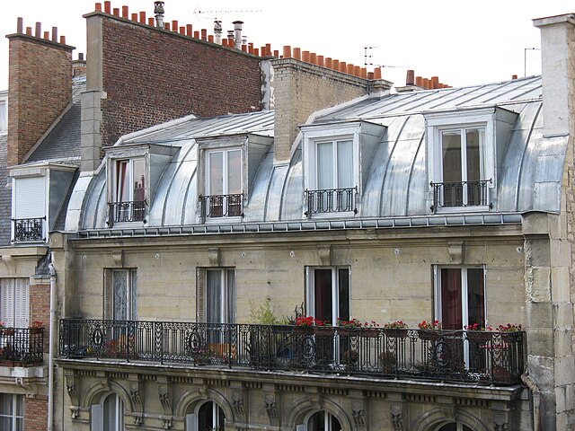 Toiture en zinc d’immeuble parisien ancien illustrant les enjeux d’étage et de luminosité lors d’un premier achat